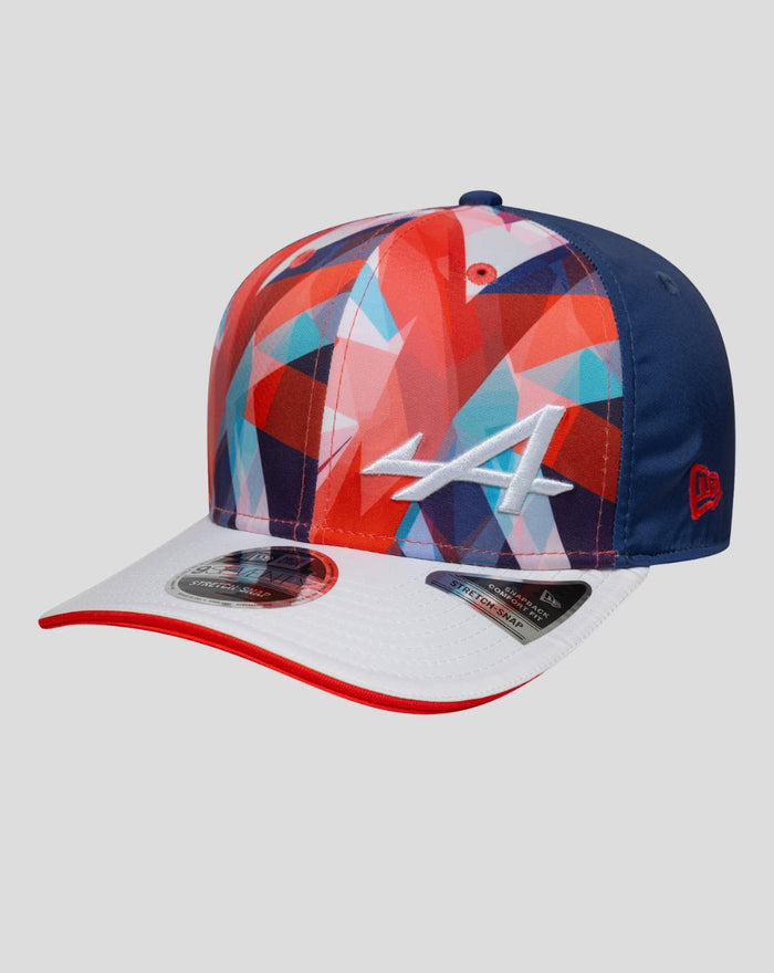 Cap with multicolor geometric panels and a white embroidered A on the front, navy blue back panels, and a white brim with red trim.