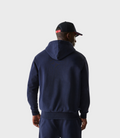 Back view of navy hoodie featuring a ribbed hem and relaxed fit