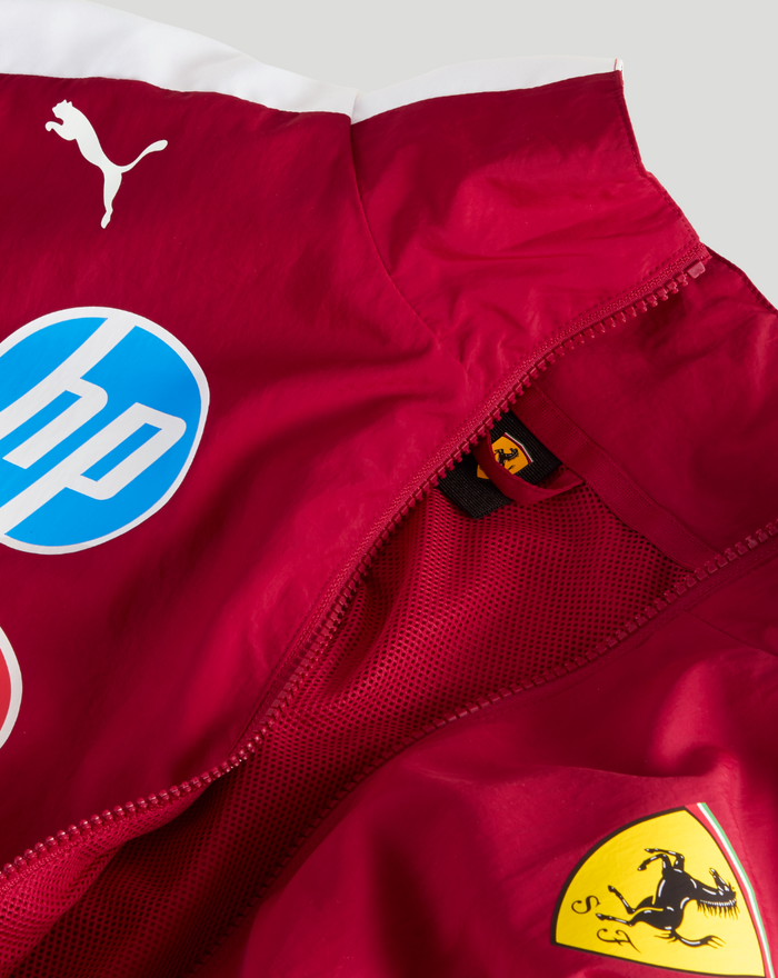 Close up of red Ferrari Drivers T7 Oversized Jacket with white stripe and sponsor patches