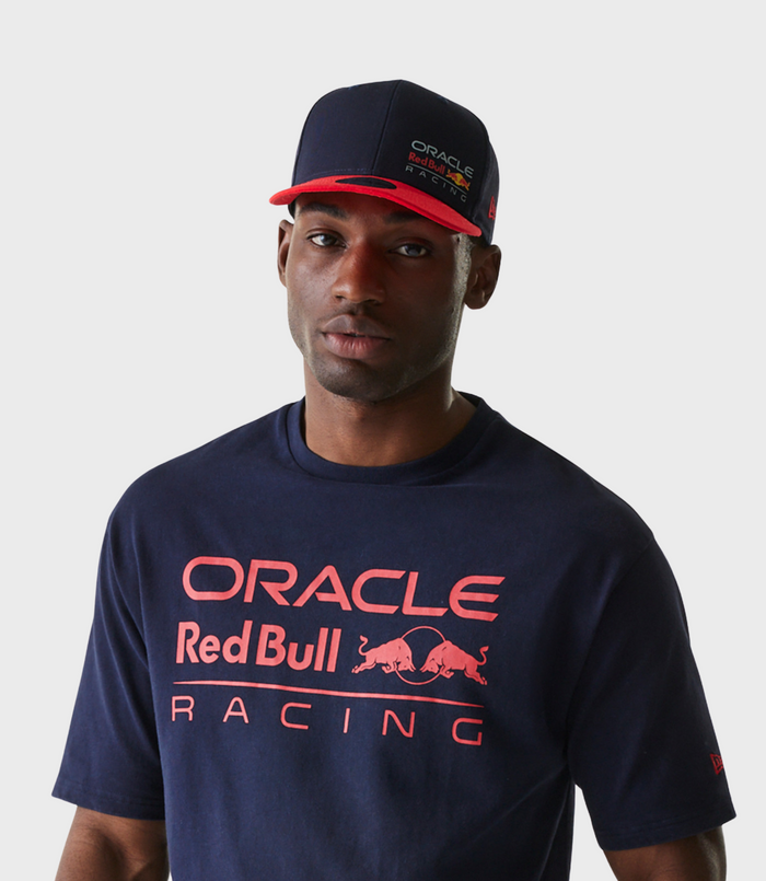 Head and shoulders of a man wearing a navy blue Oracle Red Bull Racing cap with a red brim