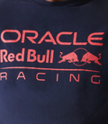 Close up of a navy blue oversized T shirt with Oracle Red Bull Racing logo on the chest and New Era flag on the left sleeve