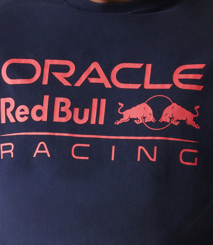 Close up of a navy blue oversized T shirt with Oracle Red Bull Racing logo on the chest and New Era flag on the left sleeve
