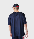 Back view of the navy blue mesh shirt showing red Forever REBL lettering along the side hem.