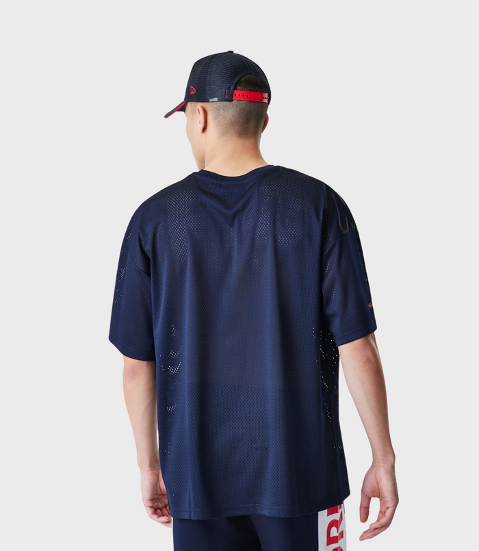 Back view of the navy blue mesh shirt showing red Forever REBL lettering along the side hem.