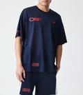 Man wearing dark blue mesh T shirt with Oracle Red Bull Racing branding and a New Era flag on the chest