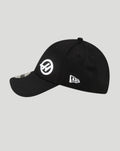 Side angle shot of a black New Era Haas Team cap with a white circular Haas logo on the side