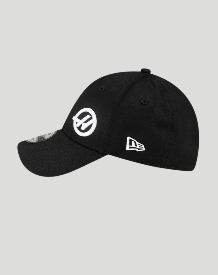 Side angle shot of a black New Era Haas Team cap with a white circular Haas logo on the side