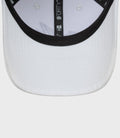 Close up of the white cap brim interior with black trim and 9FORTY label