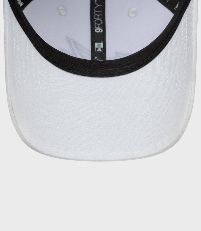Close up of the white cap brim interior with black trim and 9FORTY label