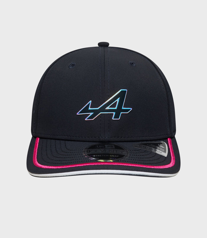Front view of navy New Era Rep Team 9Seventy Stretch Snap cap with multicolor logo on the front panel and pink edged brim
