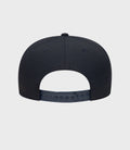 Back view of navy cap with adjustable plastic strap and pink trimmed brim visible.