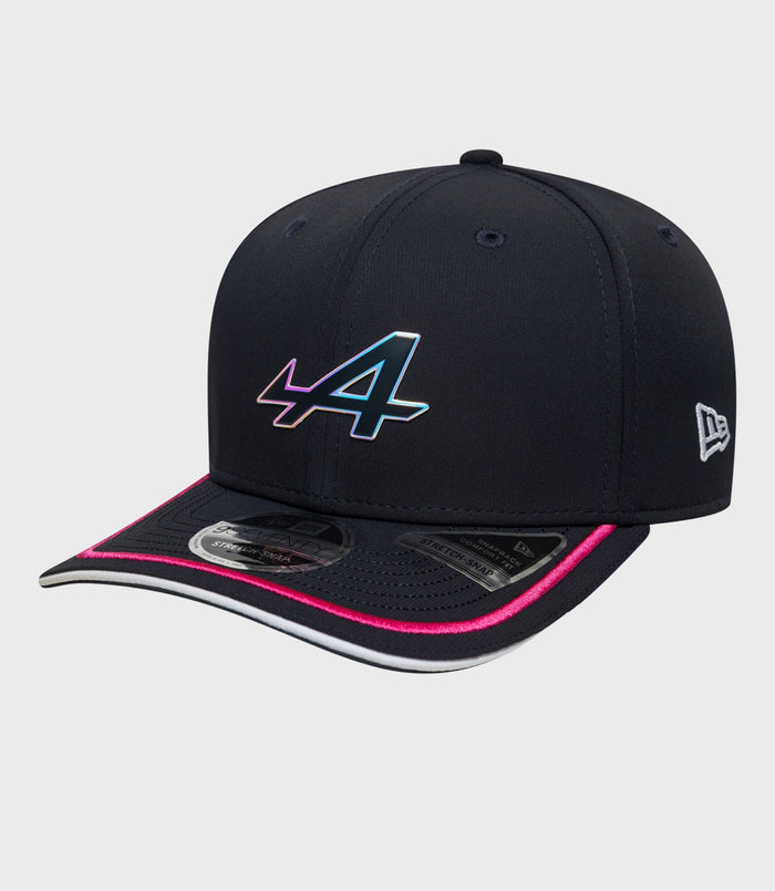 Front view of navy New Era Rep Team 9Seventy Stretch Snap cap with a colorful front emblem and pink trimmed brim