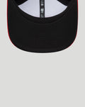 Back interior close up of the cap revealing the adjustable strap and inner sizing tag with black crown and red trim along the brim