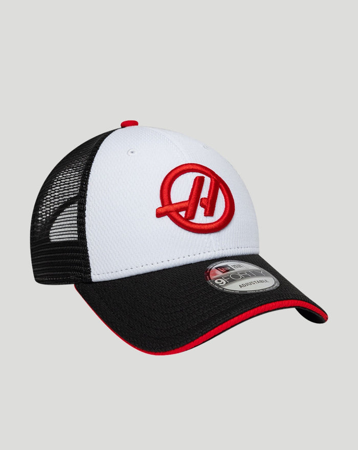Close up of white front panel cap showing red Haas embroidery and a black curved brim.