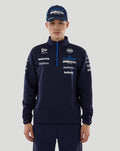 Front view of navy Williams Racing 2026 F1 men's quarter zip jacket on a model with team and sponsor logos across the chest