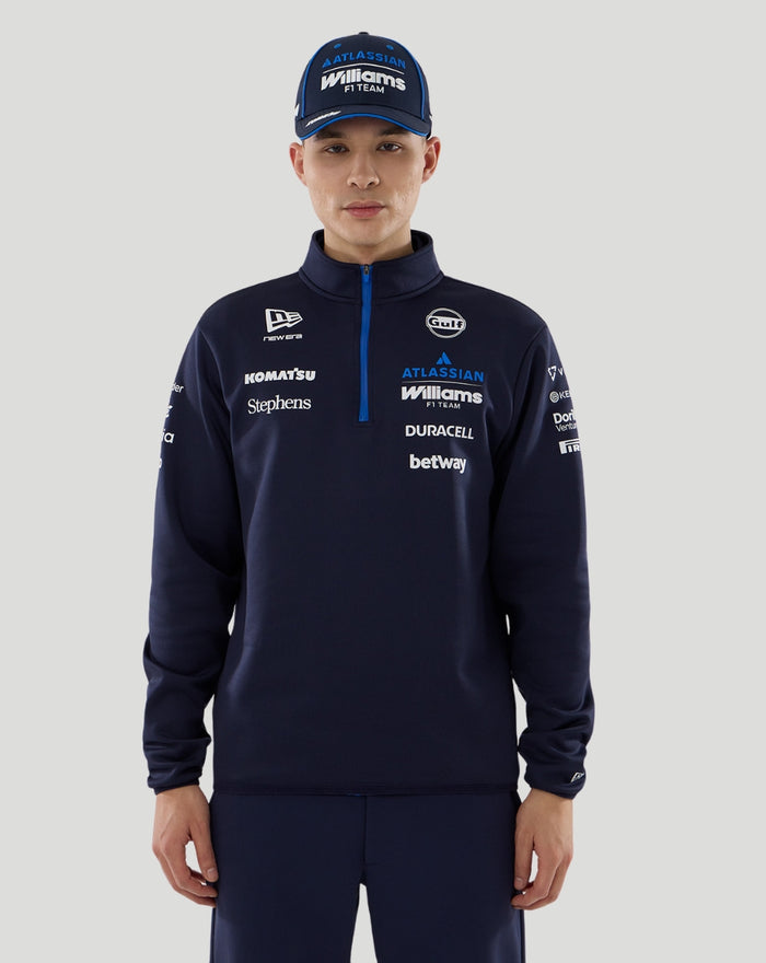 Front view of navy Williams Racing 2026 F1 men's quarter zip jacket on a model with team and sponsor logos across the chest