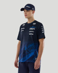 Model in navy Williams Racing T-Shirt and cap featuring Atlassian Williams branding