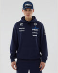 Male model in navy Williams Racing 2026 F1 hoodie with front pocket and team logos on chest and sleeves