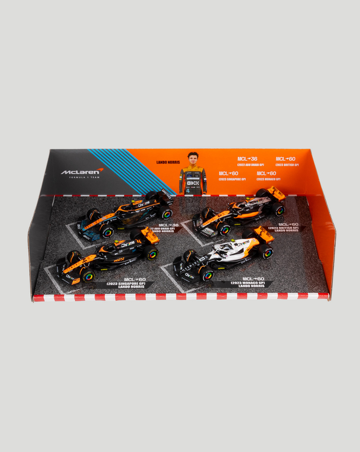 Top view of the four car set inside bright orange and gray packaging with Lando Norris figure and foam inserts