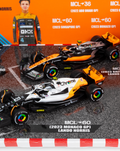 Two McLaren MCL60 F1 cars on a race diorama with Monaco GP signage and a driver cutout.