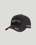 Black Porsche Motorsport cap with curved brim displaying the Porsche Motorsport logo and sponsor logos, a TAG Heuer badge on the side, and a white Puma cat emblem on the peak