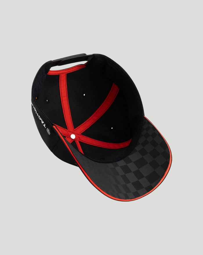 Inside view of black Porsche Motorsport cap showing red interior trim and checkered brim
