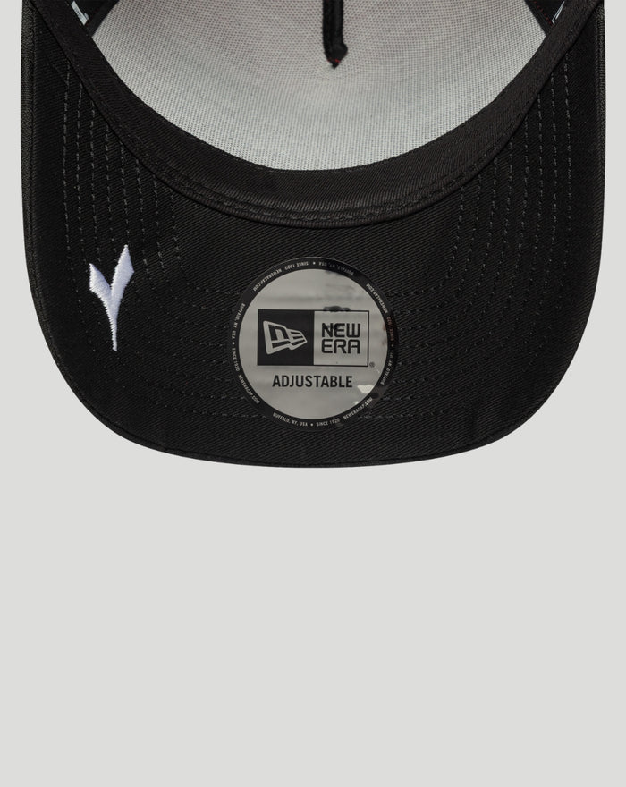 Close up of a black cap brim with a circular New Era adjustable sticker