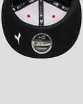 Close up of underside of black Ducati 9Fifty cap brim showing red stitching and a 9FIFTY strapback sticker