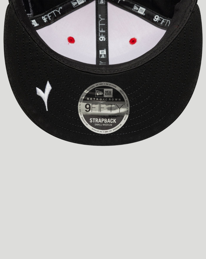 Close up of underside of black Ducati 9Fifty cap brim showing red stitching and a 9FIFTY strapback sticker