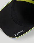 Close-up of the black cap brim with white Aramco logo and neon yellow trim