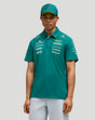 Male model wearing green Aston Martin F1 team polo with chest logos and a matching cap