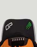 Front area of black McLaren Team Piastri cap featuring white Puma logo and green Monster Energy emblem