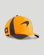 Side view of the orange Papaya McLaren Junior Team cap with curved brim and black panels
