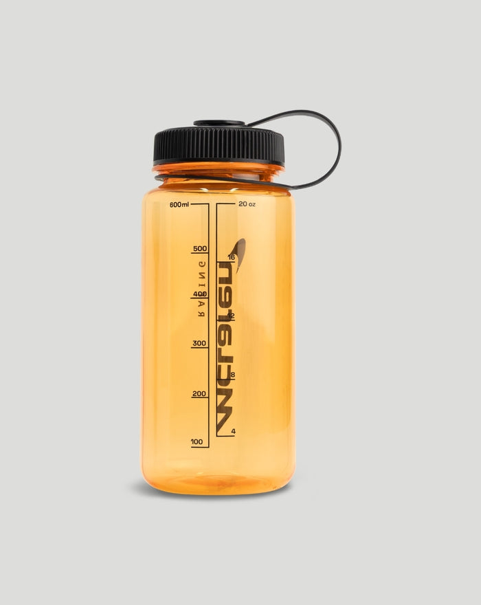 Side view of orange 600ml McLaren water bottle with measurement marks and black cap