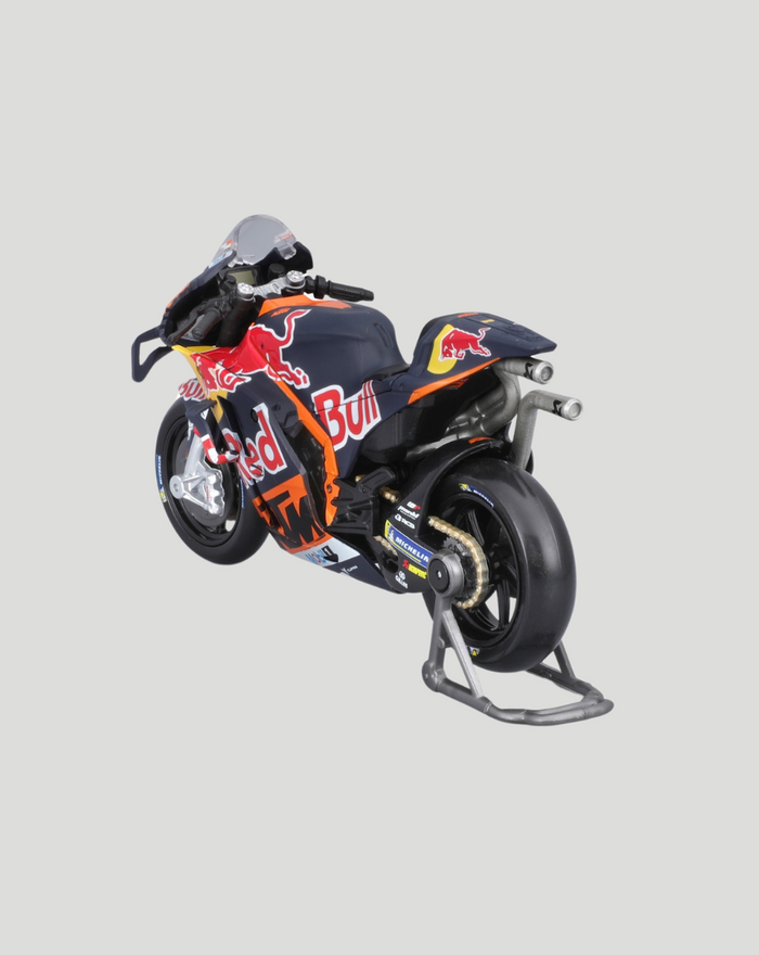 Boxed 1:18 scale Red Bull KTM Factory Racing bike model inside bright orange packaging with Maisto branding.