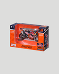 Boxed 1:18 scale Red Bull KTM Factory Racing bike model shown from the side through the packaging window.