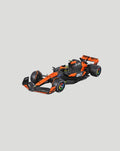 Orange black 1:24 McLaren MCL38 model car shown from a three quarter view with sponsor logos