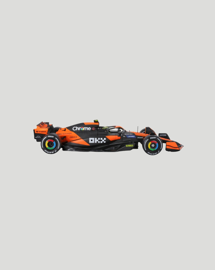 Side view of a 1:24 McLaren MCL38 2024 model car with Norris helmet in orange and black.