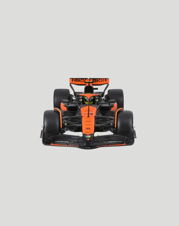 Front view of the orange and black McLaren MCL38 2024 model with Norris helmet visible.