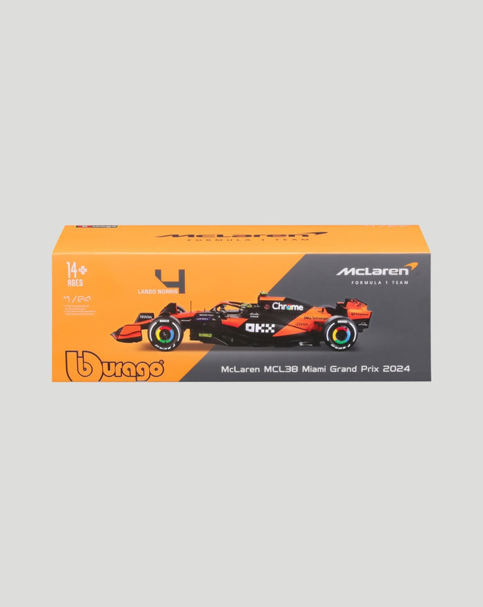 Orange and dark gray box packaging for a 1:24 McLaren MCL38 2024 model car showing a Norris helmet graphic
