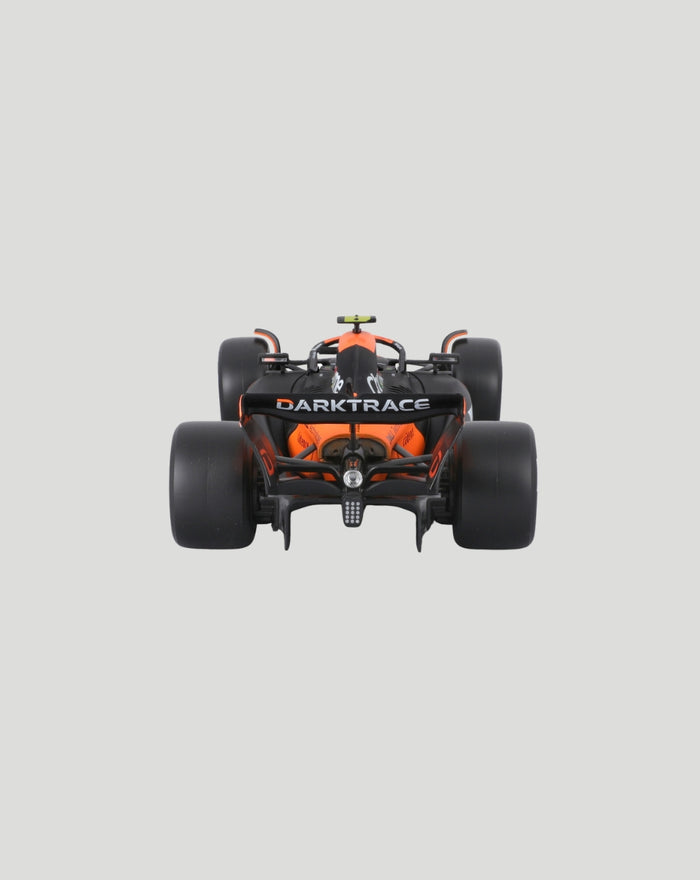 Rear view of the orange and black McLaren MCL38 2024 model with Darktrace branding on the rear wing.