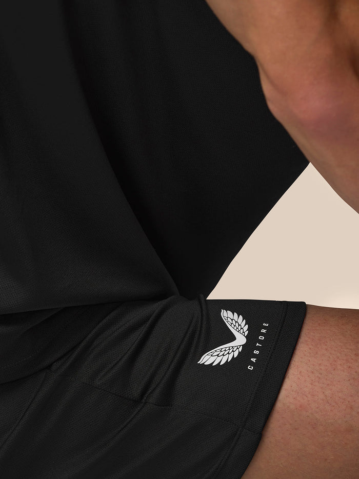 Close-up of black Adapt Training 7 inch shorts showing Castore logo on the right thigh.