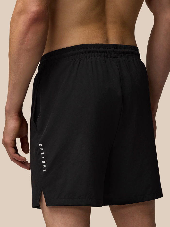 Side view of black Adapt Training 6 inch Shorts showing vertical CASTORE branding on the left leg