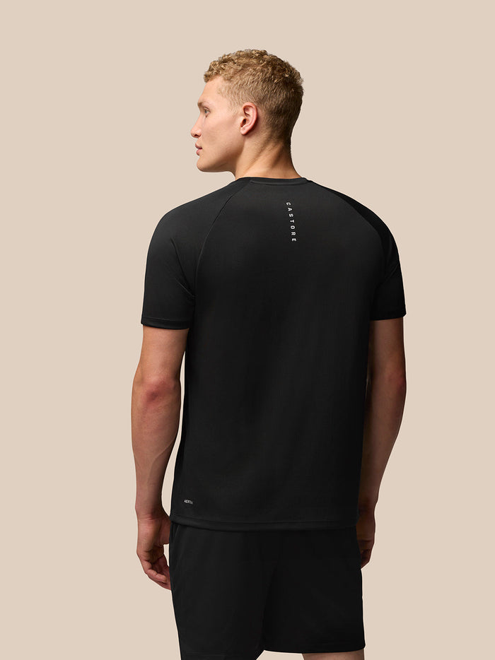 Back view of black Adapt Training T-Shirt showing vertical Castore branding along the upper back