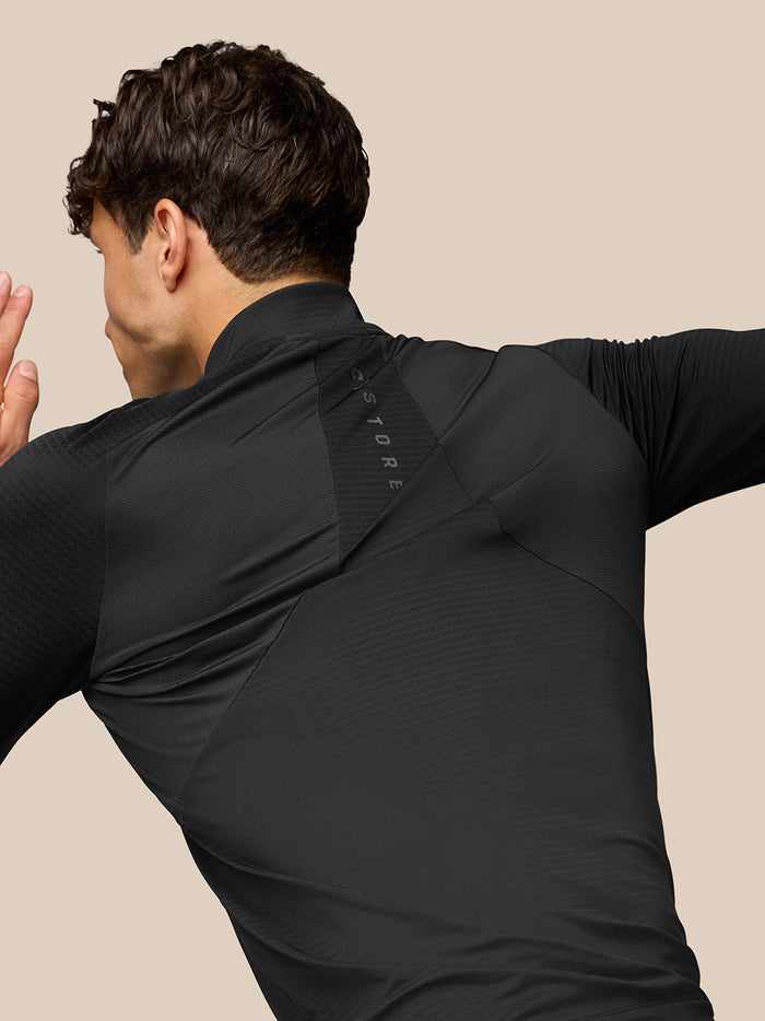 Close-up of back shoulder area on black Apex Training top showing Aeromesh branding