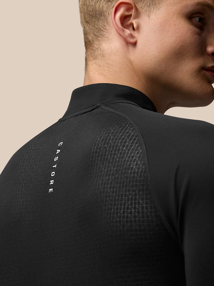 Back close up of black Adapt Print 1/4 Zip top showing geometric pattern with Castore and Aertek branding.