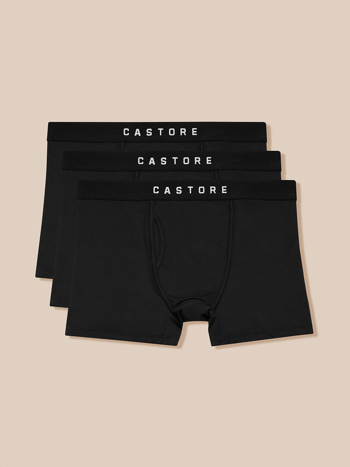 Three black Castore boxer shorts with branded waistbands stacked together.