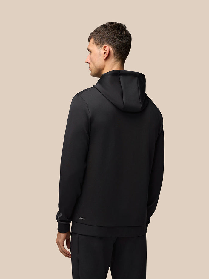 Male model in black Flex Hoodie with Castore branding on chest against a neutral background