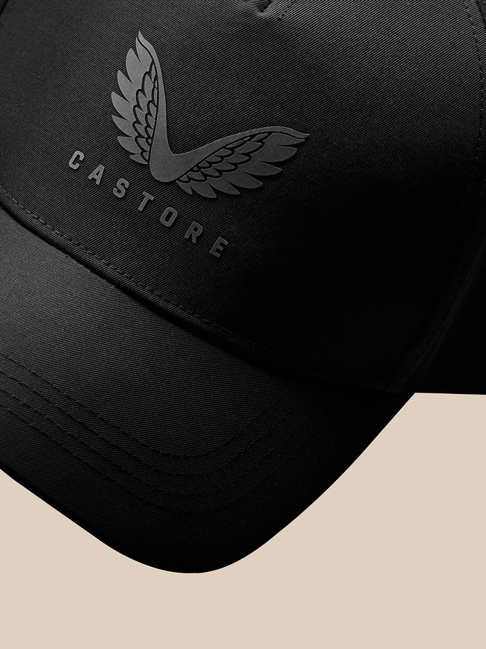 Close up of a black nylon cap showing the Castore wing emblem and brand name