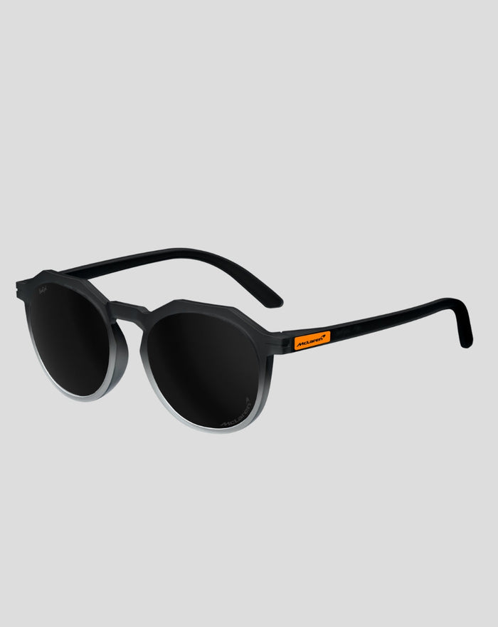 SunGod x McLaren Core Zephyrs sunglasses front three quarter view with black frame round lenses and orange temple badge